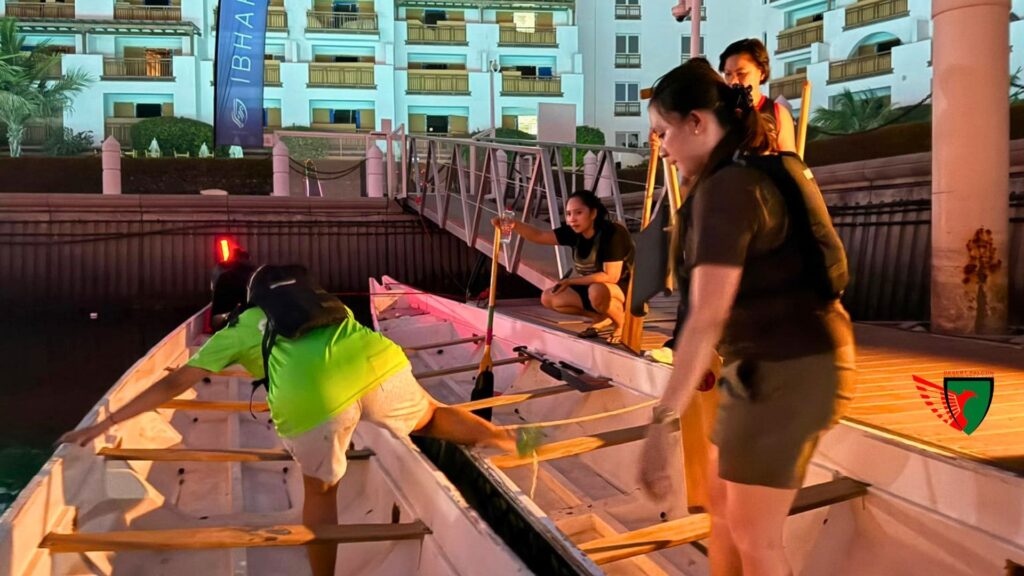 Desert Falcons members preparing the dragon boat before evening training.